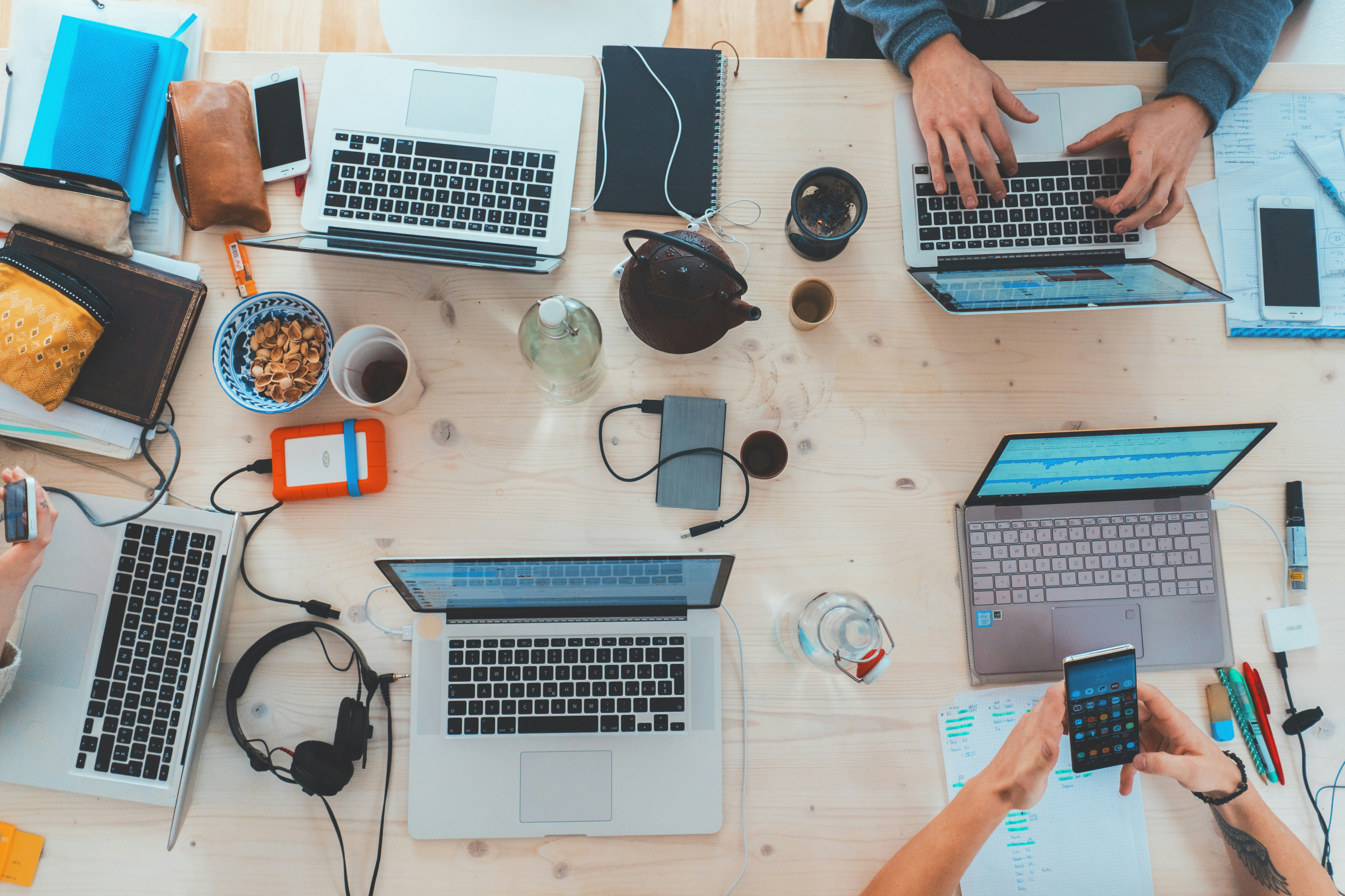 Aerial view of laptops and accessories on wooden table
