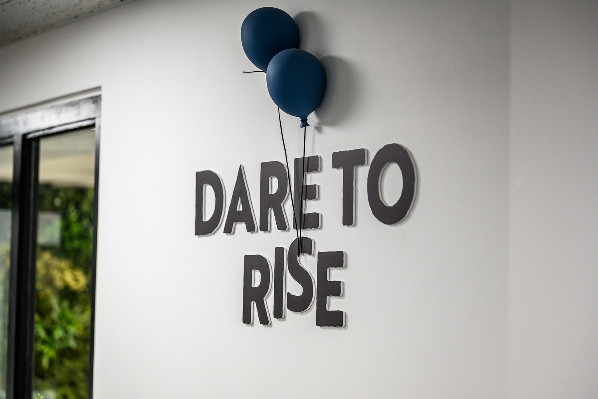 "Dare to Rise" decoration on our studio wall, the rise being lifted by ballons