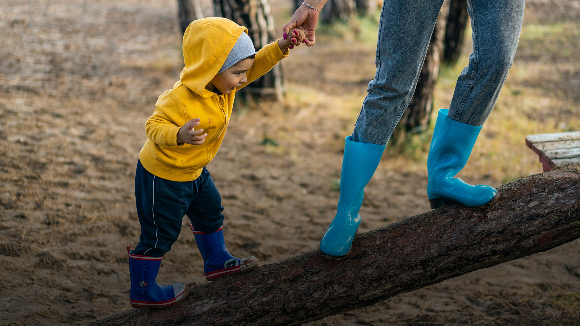 Child and guardian in blue boots