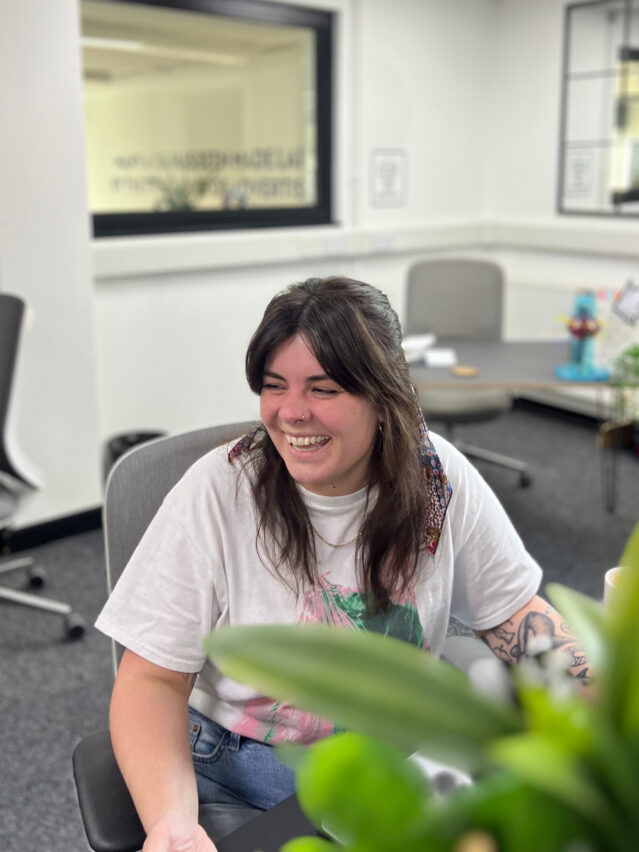 Woman sitting at desk while laughing