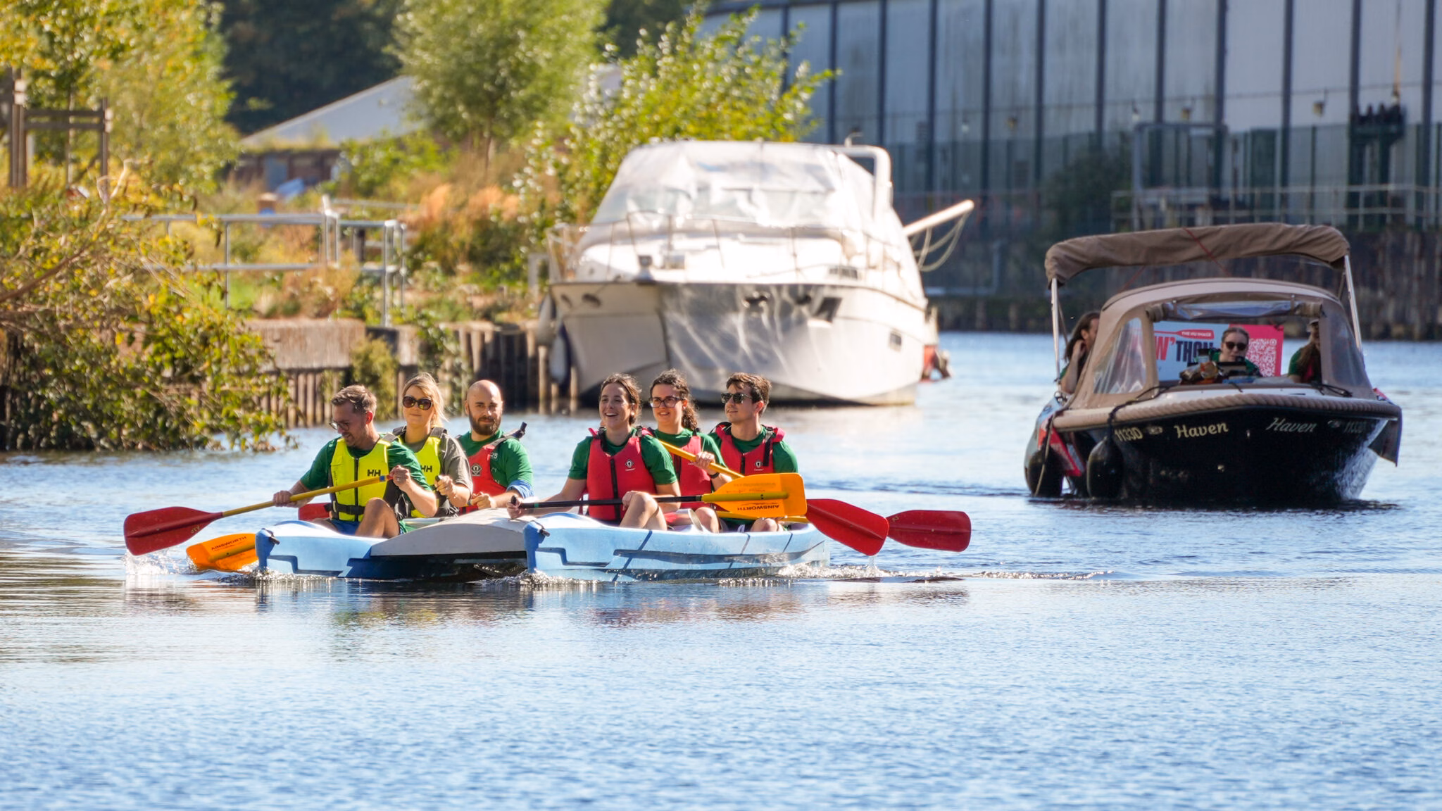 Canoe and support boat on the water in Norwich