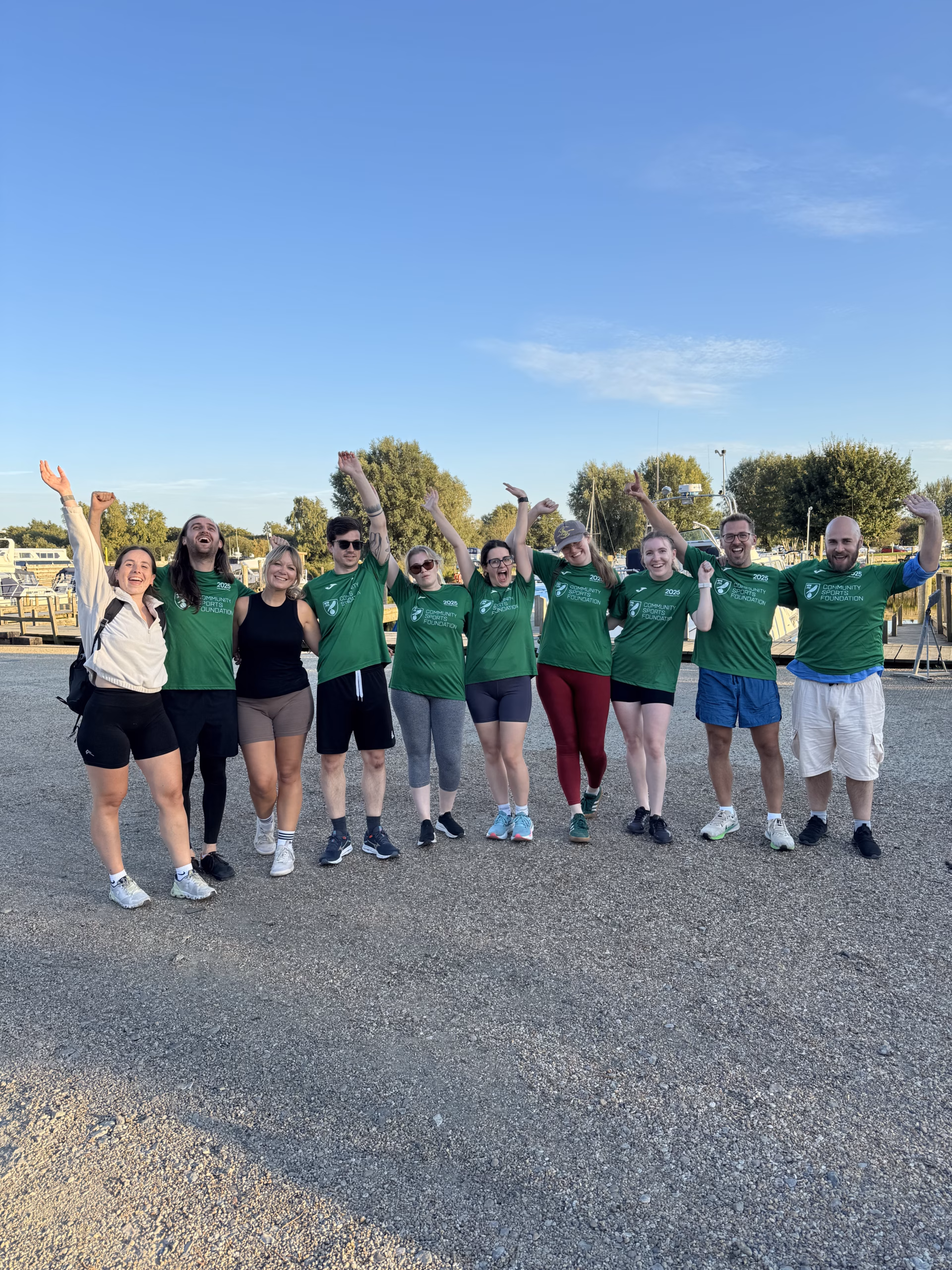 Team celebrating after finishing rowing challenge