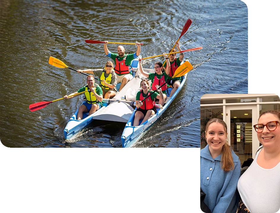 Team in canoe and Ellie and Meg smiling